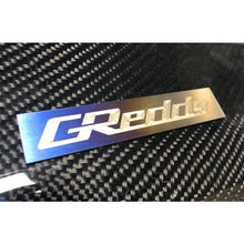 Load image into Gallery viewer, GReddy Titanium Emblem - (105x20mm) (18000201)